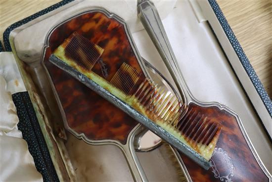 A cased plated and tortoiseshell brush set